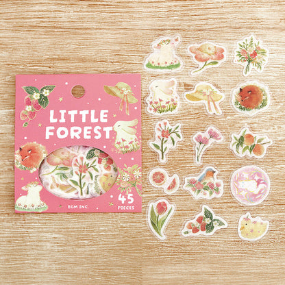 Sticker set with 'Little Forest' packaging on a wooden surface