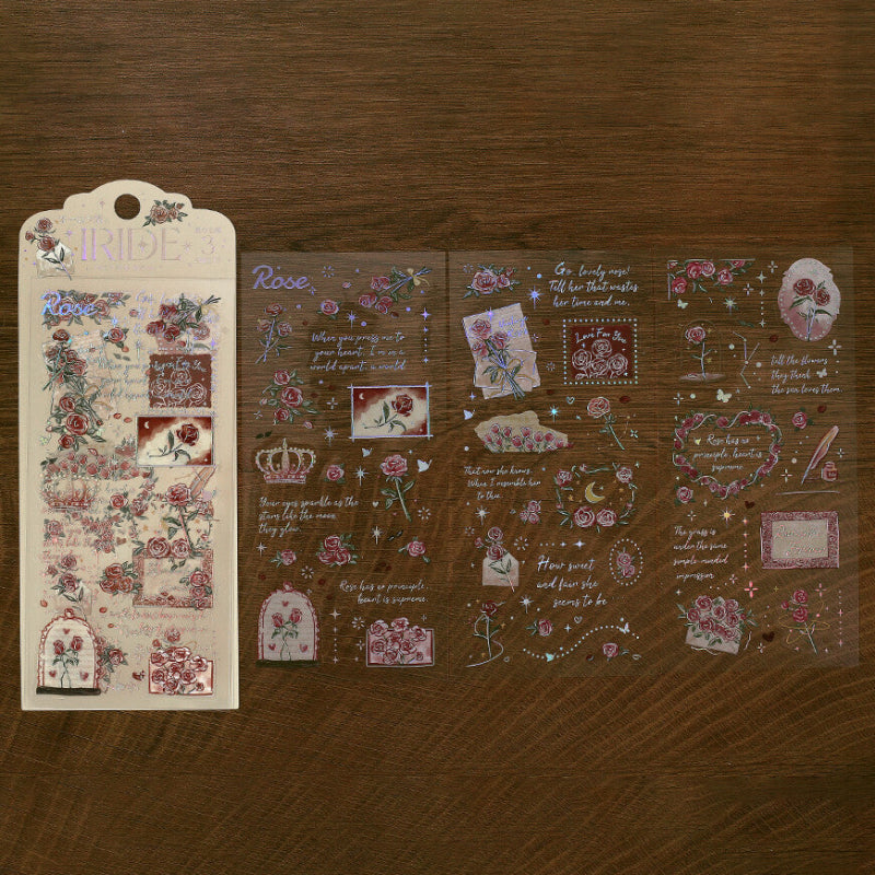 Decorative sticker sheets with floral and text designs on a wooden surface